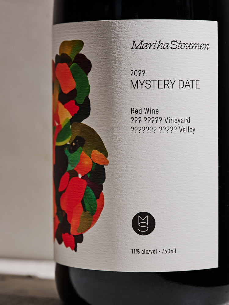 Wine bottle label with colorful collage illustration and text on a neutral background