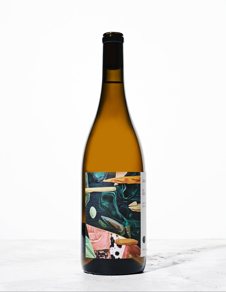 A brown wine bottle sits on a white background. The label features teal, pink, and orange cut outs in a collage pattern.