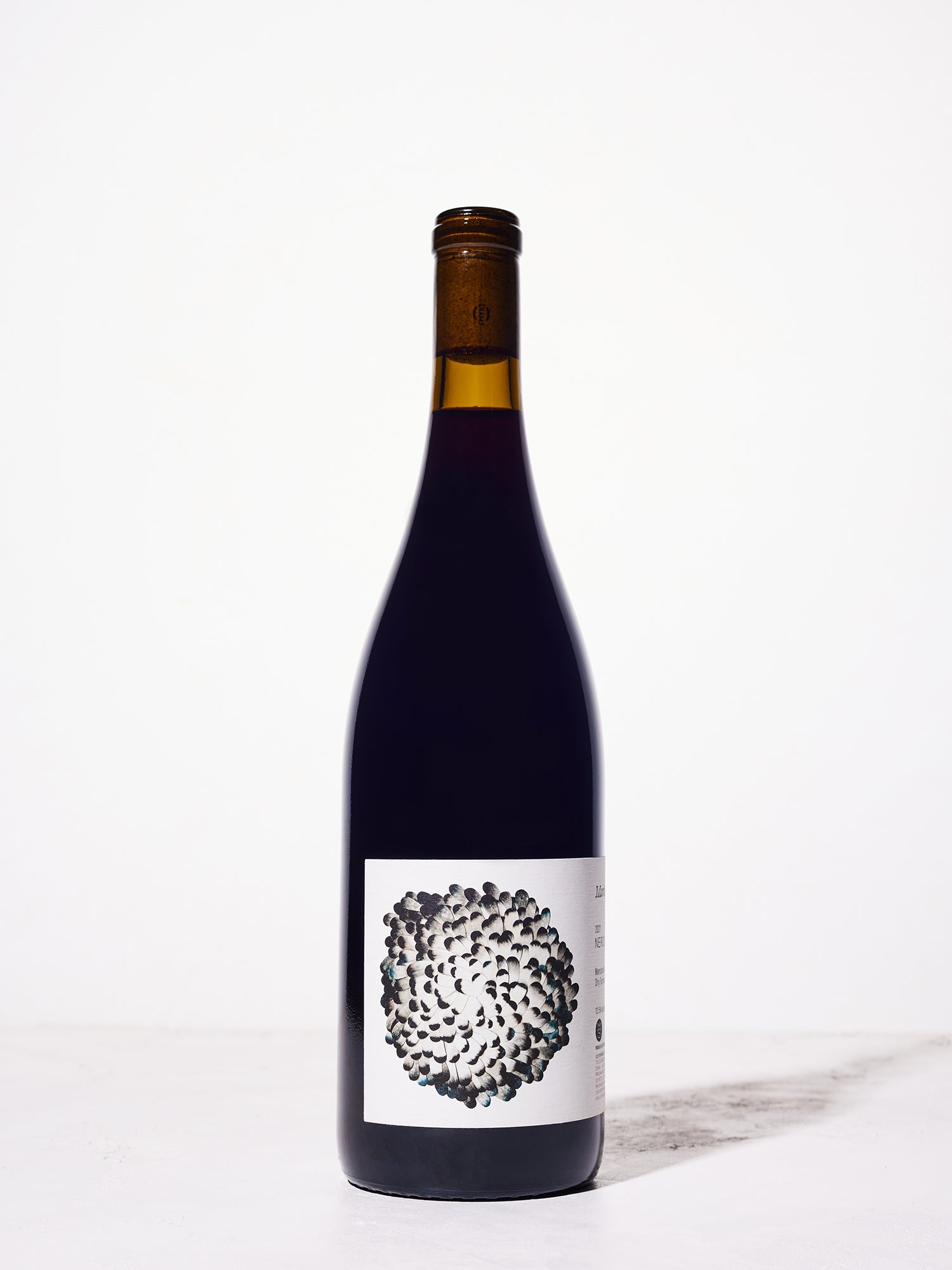 Wine bottle with a unique black and white label on a white background