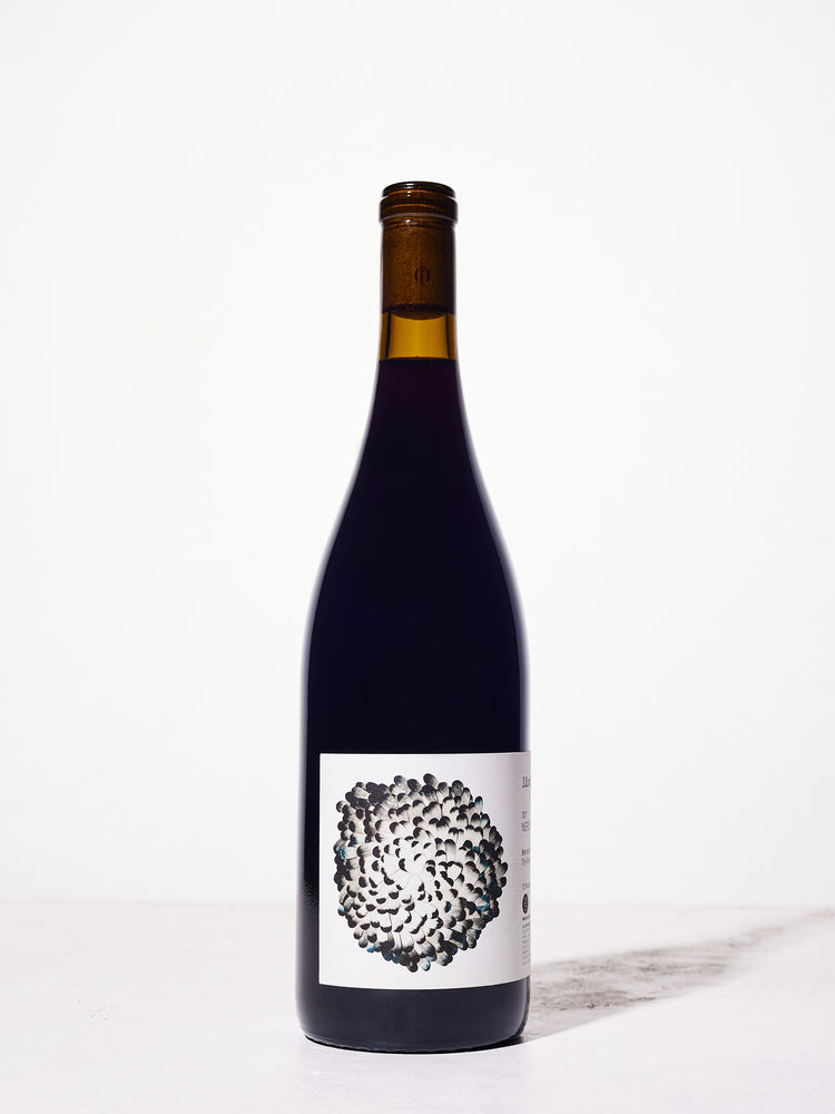 Wine bottle with a unique black and white label on a white background