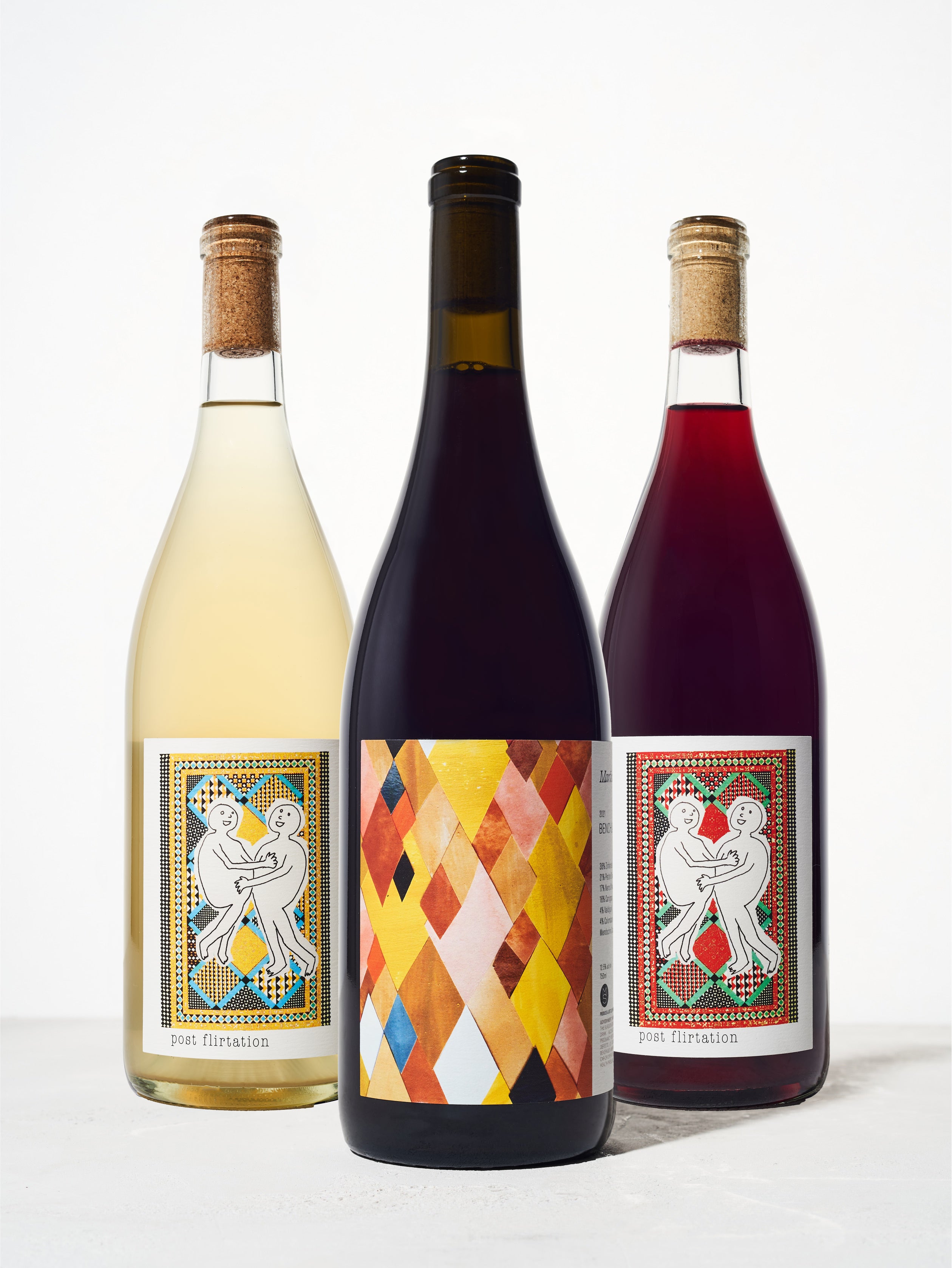 Three bottles of assorted wine on a white background.