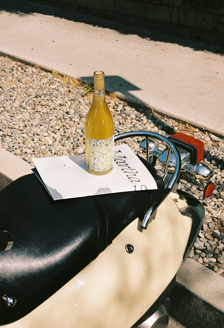 Martha Stoumen Honeymoon 2021 on the back of a yellow Vespa scooter.