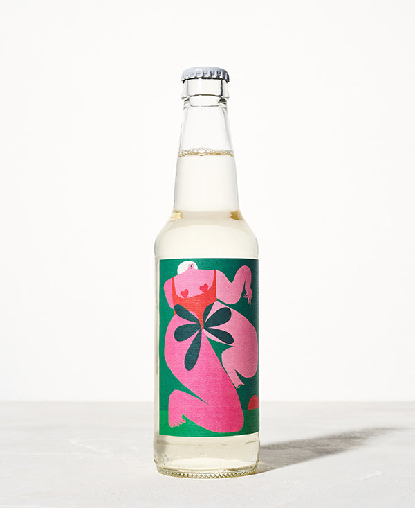 Clear glass bottle with a colorful abstract label featuring pink, red, and green shapes. The background is bright and minimalist, conveying a modern tone.